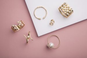 Pearl,Golden,Bracelets,And,Ring,On,Pink,Background,-,Pearl